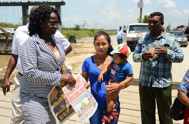 Denita Harris receiving a copy of the Guyana Chronicle from Kim Halley of the Guyana National Newspapers Limited ( Photos by Samuel Maughn)