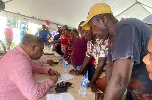 Minister within the Ministry of Public Works, Deodat Indar, reaching with residents at Darthmouth 