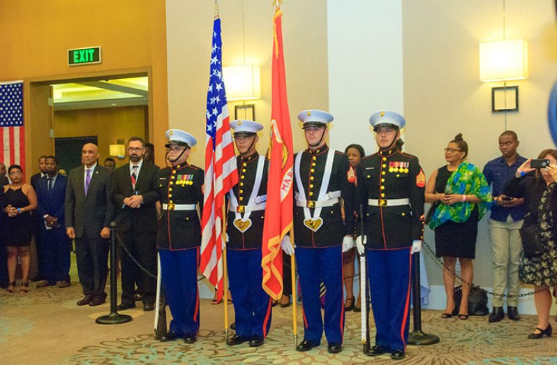 Representatives of the U.S. Navy stand at attention as part of a presentation during that country’s 241st Independence celebration at the Marriott Hotel (Delano Williams photo)