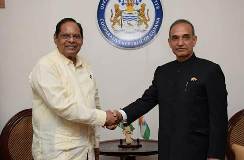 Prime Minister Moses Nagamootoo greets India's Minister of State Dr. Satya Paal Singh, during a courtesy call at the prime minister’s official residence on Main Street, Georgetown