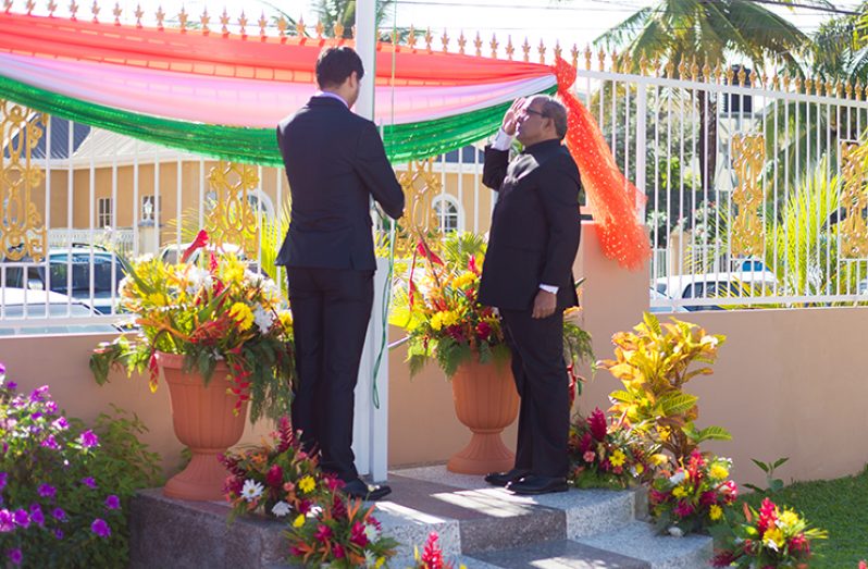 Indian High Commissioner to Guyana, Venkatachalam Mahalingam, salutes as the Indian flag is hoisted to celebrate India’s 70th Republic Day (Delano Williams photo)