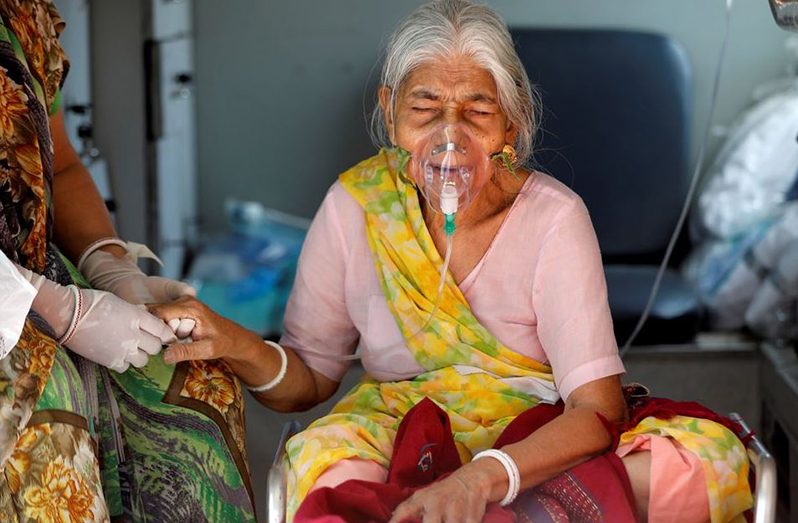 Lilaben Gautambhai Modi, 80, wearing an oxygen mask, sits inside an ambulance as she waits to enter a COVID-19 hospital for treatment, amidst the spread of the coronavirus disease (COVID-19), in Ahmedabad, India, May 5, 2021 (REUTERS/Amit Dave/File Photo)