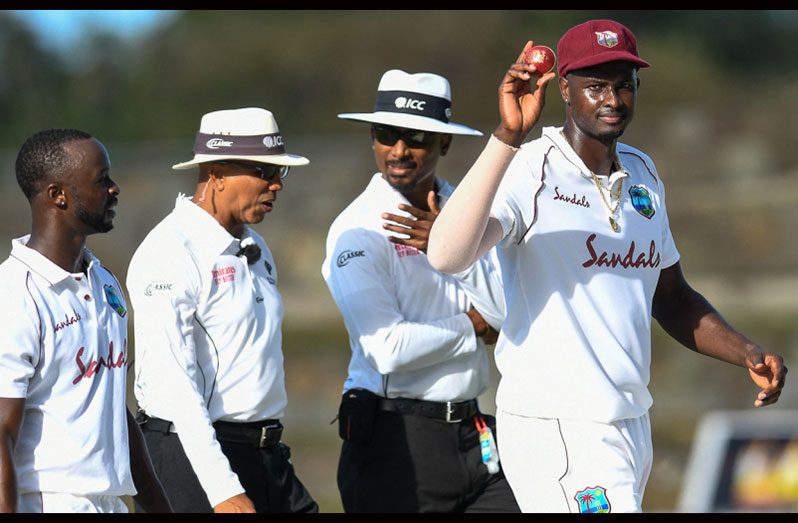 Jason Holder holds the ball aloft after completing his eighth five-wicket haul in Tests, West Indies vs Sri Lanka, 1st Test, North Sound, 1st day, March 21, 2021 © RANDY BROOKS/AFP/Getty Images