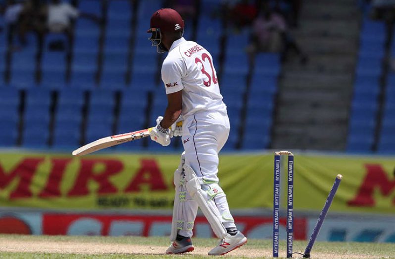 John Campbell looks on after his leg stump is uprooted. (Associated Press)