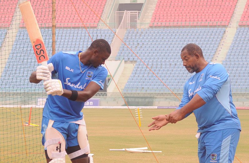 West Indies head coach Phil Simmons working with Jason Holder on a recent tour.