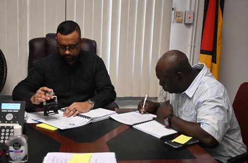 A contractor signing his project document