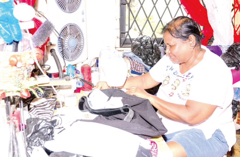 Indra Dhanai at her sewing machine (Delano Williams photo)