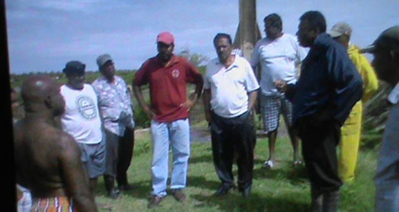 Minister Baksh and Region Two Chairman, Mr. Parmanand Persaud inspecting a sluice at Hampton Court
