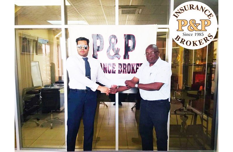 P&P Insurance Brokers’ executive director Vikash Panday (left) hands over the sponsorship cheque to GSCL president Ian John