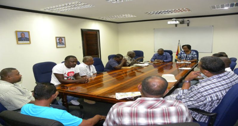 Minister of Public Infrastructure, David Patterson, and Minister within the Ministry of Public Infrastructure, Annette Ferguson, interact with the Berbice bus drivers