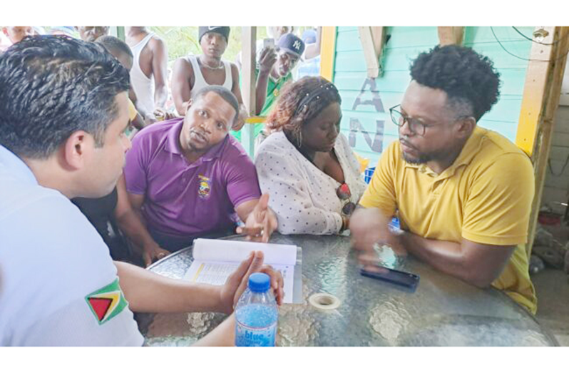 Culture, Youth and Sport Minister, Charles Ramson, engaging residents of Victory Valley on Monday (DPI photo)