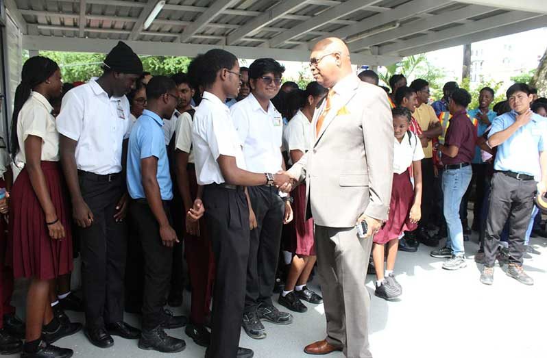Minister of Public Works Bishop Juan Edghill interacts with participates of the work-study programme at the Ministry of Public Works