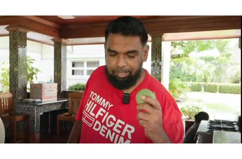President Dr. Irfaan Ali holds a fresh mango picked from his garden