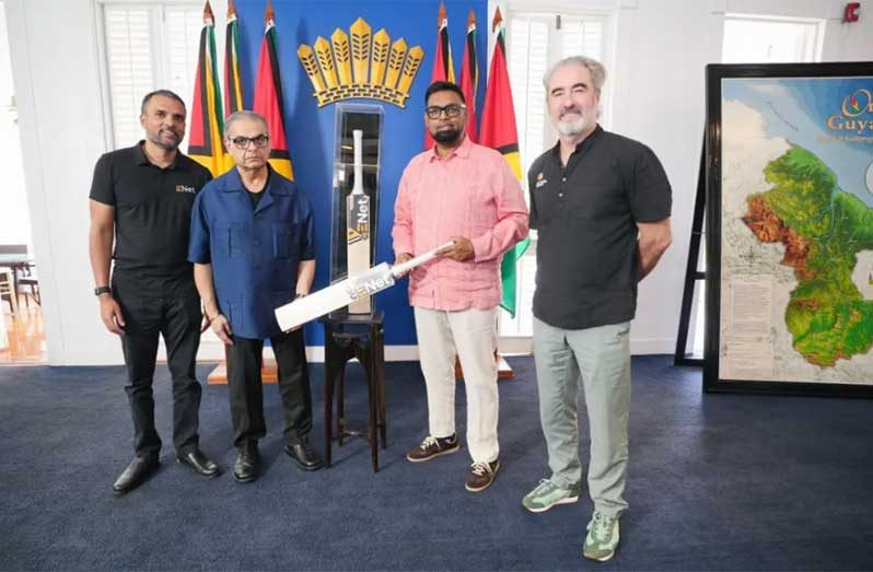 President Dr Mohamed Irfaan Ali (second right) is flanked by Director of the ExxonMobil Guyana Global Super League, Jamie Stewart (left) and Chief executive officer of E-Networks, Vishok Persaud, along with Rakesh Puri (right)