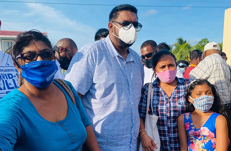 President irfaan Ali with Venezuelan re-migrants Sherry and Sharron at Suddie.
