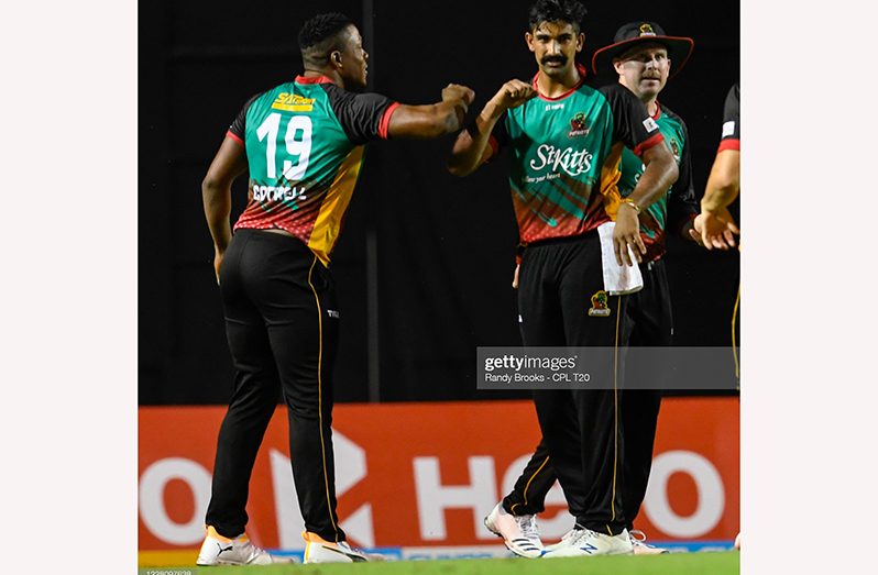 Ish Sodhi (C), Sheldon Cottrell (L) and Ben Dunk (R) of St Kitts & Nevis Patriots celebrate the dismissal of Jason Holder of Barbados Tridents during the Hero Caribbean Premier League match 2 between the two teams. (Photo by Randy Brooks - CPL T20/CPL T20 via Getty Images)