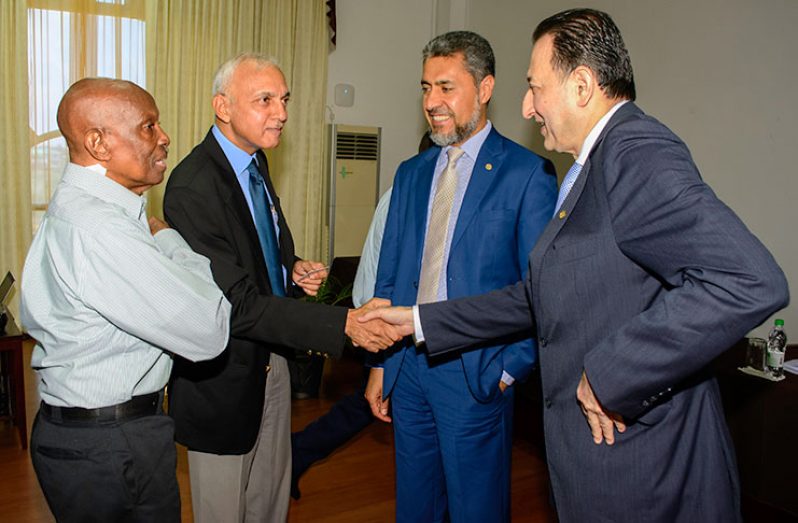 Minister of Communities Ronald Bulkan greets the Acting Director  for the bank’s Country Programme, Mohammed Jamal Aisaati, in the presence of  Islamic Development Bank Vice-President Sayed Aqa and Chairman of the Board of Directors of the Central Housing and Planning Authority, Hamilton Green