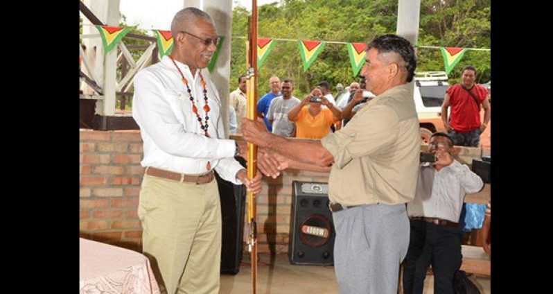 President David Granger receiving an arrow and bow from Daniel Allicock of Surama Village, one of the communities near the Iwokrama rainforest. (Ministry of the Presidency photo)
