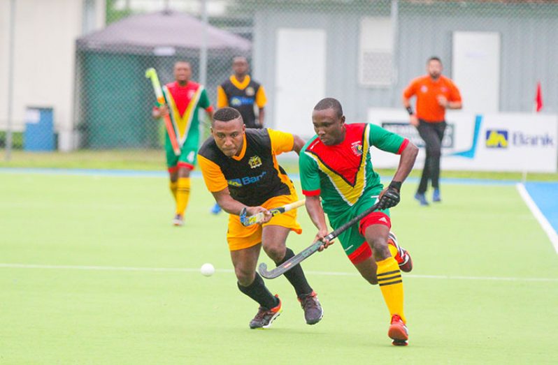 Guyana’s Aroydy Bradford (left) battling his Jamaican counterpart during yesterday’s clash. The two will meet again in today’s final of the CAC Games qualifier tournament.
