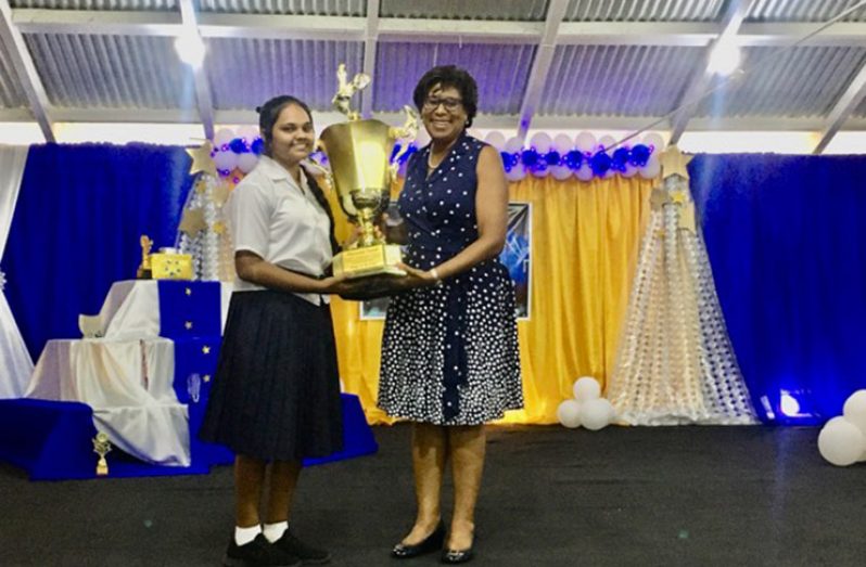 Minister of Public Telecommunications   Cathy Hughes presenting 14-year-old Hemanchali Samlall with her award