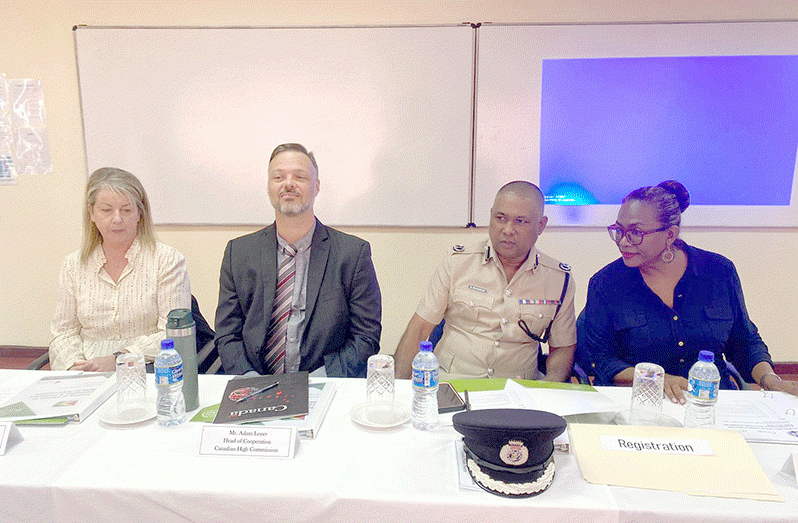 Deputy Commissioner 'Operations' Mr. Ravindradat Budhram (second from right) flanked by JES country representative and Project Director Lisa Thompson (at right); Canadian High commission Head of Cooperation Adam Loyer (third from right) and Police Specialist Consultant and Trainer, Janis Gray (at left)