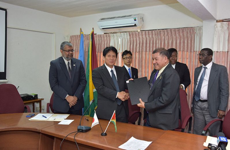 JGRANT : The provision of grants to the three organisations in Guyana was solidified with a handshake between Counsellor and Deputy Head of Mission of the Embassy of Japan, Yoshinori Yakabe (centre) and Minister of Indigenous People’s Affairs, Sydney Allicock (right). Included in photograph is Honorary Consul-General to Japan, Kashir Khan (left) (photo by Samuel Maughn)