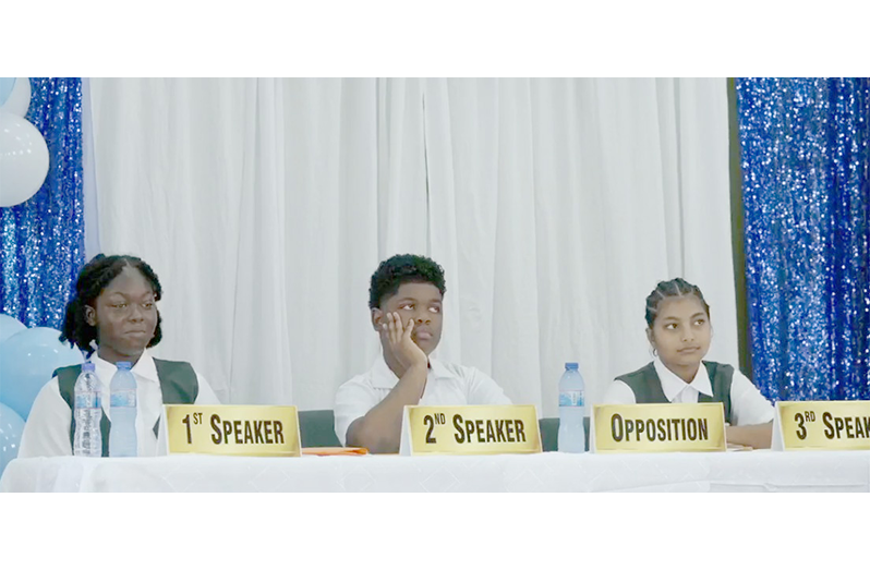 (from left) Nephlyah Farrel, Tahir Gomes, and Rhea Persaud of Mackenzie High School, during the final leg of the competition on Friday