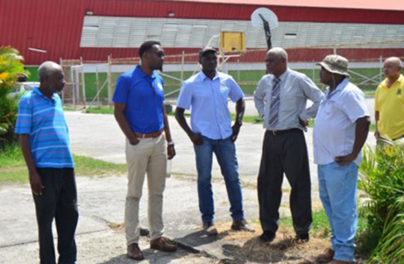 Director of Sport Christopher Jones (second from right) in discussion with the contractors on the site at the National Gymnasium where the multipurpose court will be constructed. (DPI photo)