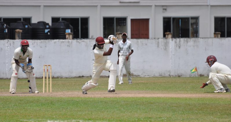 Great shot Steven! From left, wicketkeeper Kevon Boodie, Parmesh Parsotam and Mark Gonsalves (stooping) look on admirably as GCB Developmental XI skipper Steven Jacobs drives down the ground yesterday.