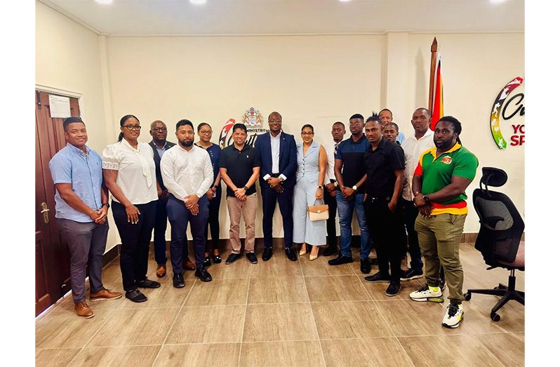 Minister within the Ministry of Culture, Youth and Sport Steven Jacobs (standing centre) with the group of current and former national athletes