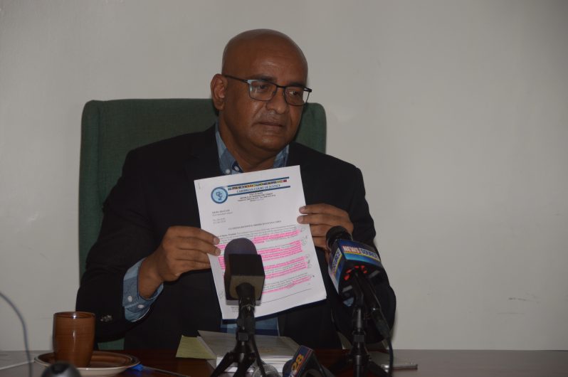 Leader of the Opposition, Bharrat Jagdeo, holding a copy of the consequential orders delivered by the CCJ