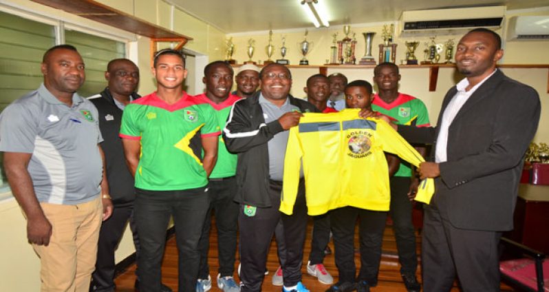 Head Coach Jamaal Shabazz makes a presentation to Director of Sports Christopher Jones during the National U-23 team’s courtesy call yesterday