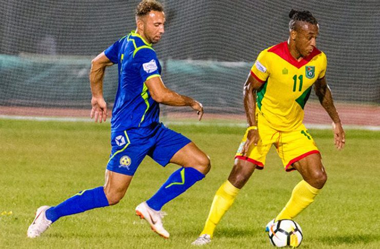 FLASHBACK! Barbados’ Hallam Hope (left) about to challenge his former Bury FC teammate Neil Danns during the 2–2 clash between Guyana and Barbados in the CONCACAF Nations League at the National Track and Field Centre. (Samuel Maughn photo)