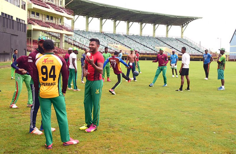 Devendra Bishoo, Veerasammy Permaul and Assad Fudadin share a light moment ahead of their training yesterday at the Guyana National Stadium, Providence. (Photos by Adrian Narine)