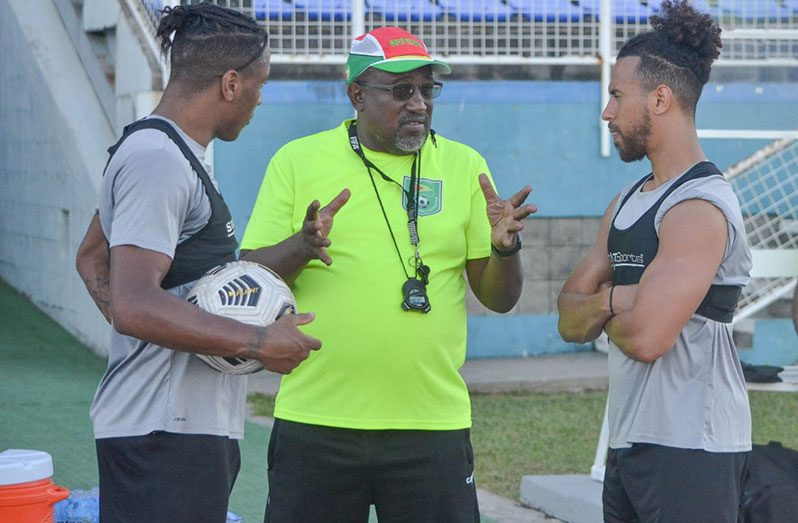 Golden Jaguars coach Jamaal Shabazz sharing a moment with Neil Danns (first from left) and Sam Cox.(Newsroom photo)
