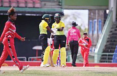 Jamaica Women captain Rashada Williams (3rd left) and fellow opener Chrishana McKenzie meet mid pitch during their match against Trinidad & Tobago Women in the CG United Women’s Super 50 Cup at Warner Park on Monday. (Photo: CWI Media)