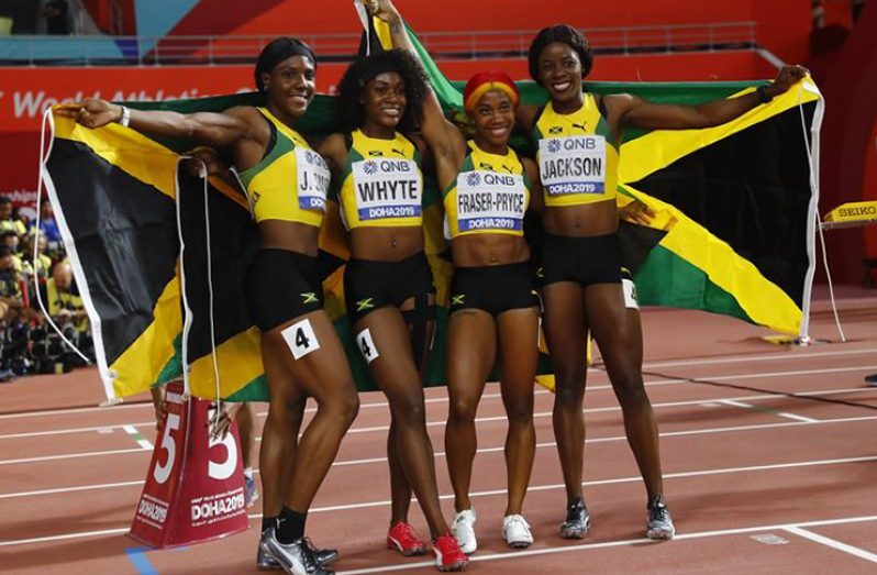 Jamaica's Shelly-Ann Fraser-Pryce, Natalliah Whyte, Jonielle Smith and Shericka Jackson celebrate winning gold. (REUTERS/Kai Pfaffenbach)