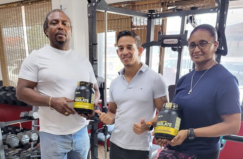 Fitness Express' Jamie McDonald flanked by Nadina Taharally (right) and Roger Rogers.