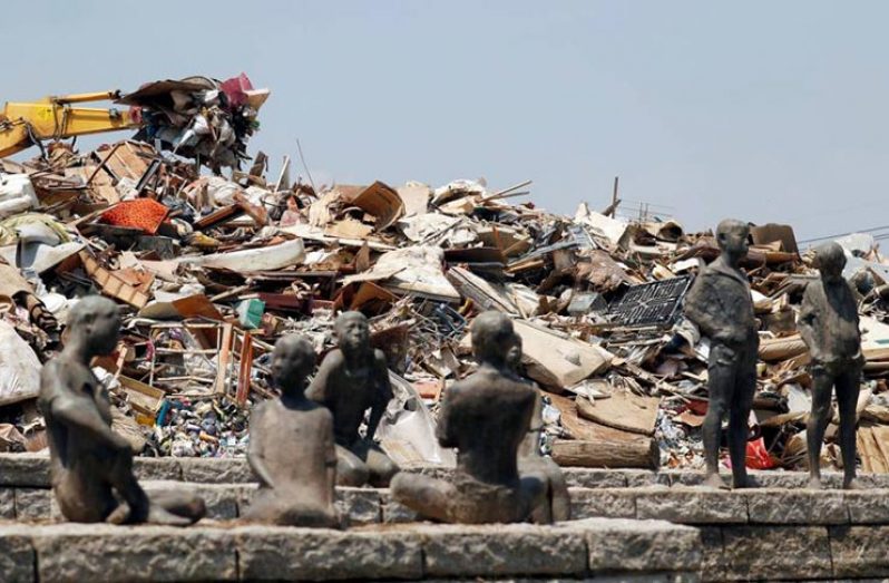 Household waste collected in the wake of heavy flooding in western Japan is piled up at a temporary collection site in Kurashiki, Okayama Prefecture, on Saturday (Reuters)