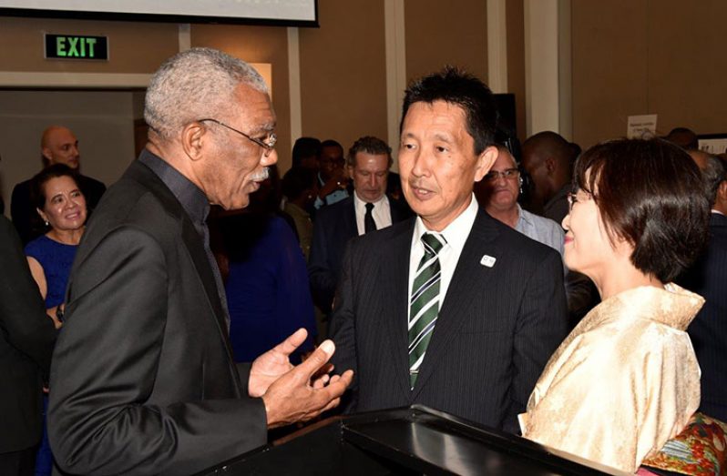 President Granger shares a light moment with Non-Resident Ambassador of Japan to Guyana, Mr. Mitsuhiko Okada and Mrs. Okada at the reception on Thursday evening