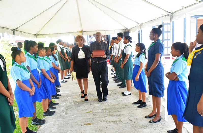 Members of the Guyana Girl Guides Association formed an honour guard as relatives of the late Carmen Jarvis take her urn out of the Smith Memorial Congregational Church on Brickdam, Friday