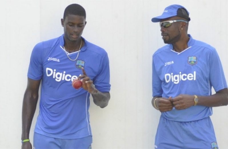 Windies captain Jason Holder (left) and Curtly Ambrose.