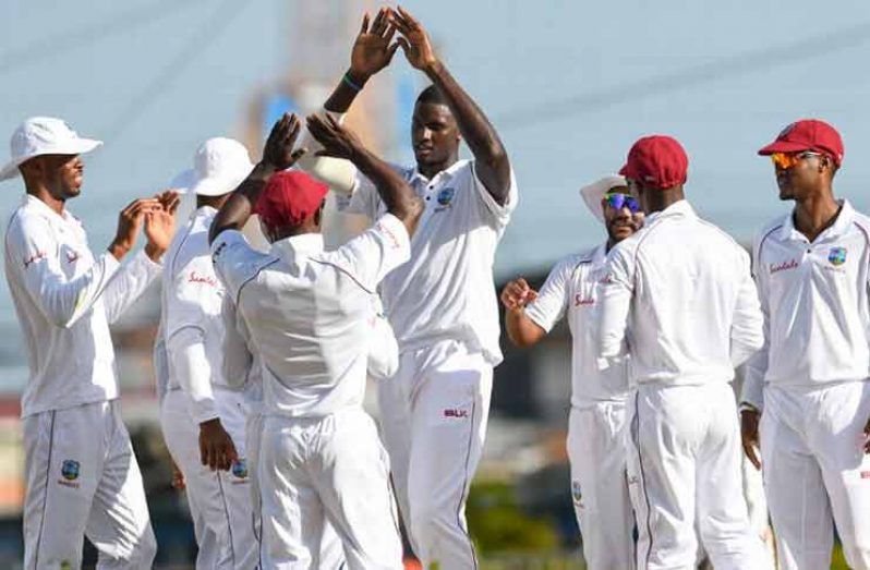 Jason Holder celebrates a dismissal with his team-mates CWI Media/Randy Brooks