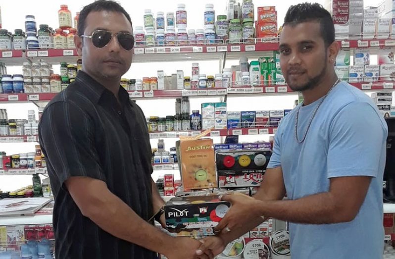 Umpire and coach Zaheer Mohamed (left) receives the donation on behalf of WCC from Jason Bacchus of Mike’s Pharmacy.