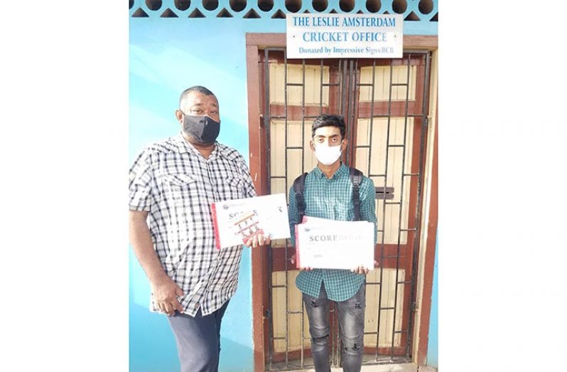 BCB president Hilbert Foster hands over donation to Javed Karim of West Berbice.