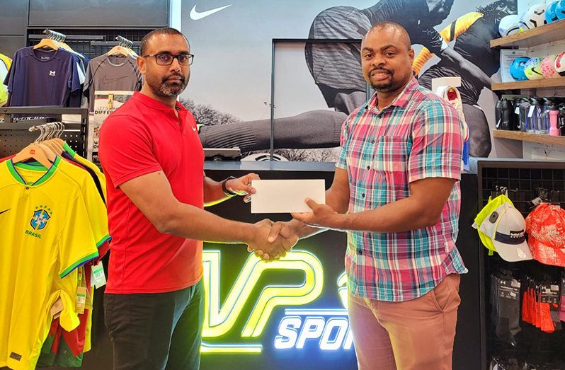 Managing Director of MVP Sports, Ian Ramdeo (left) makes his contribution to the resuscitation of the Golden Mile to Edison Jefford at the Giftland Mall Store