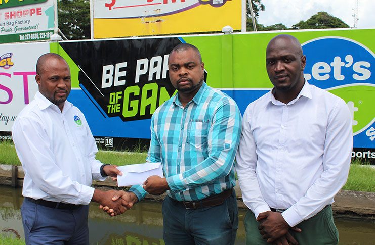 Let’s Bet Sports Brand Manager Ian DeBarros (first from left) and Let’s Bet Sports Brand Ambassador Rawle Toney made a presentation to Edison Jefford, organizer for the Jefford Track and Field Classic, to announce their affiliation with the event that will be celebrating 10 years.