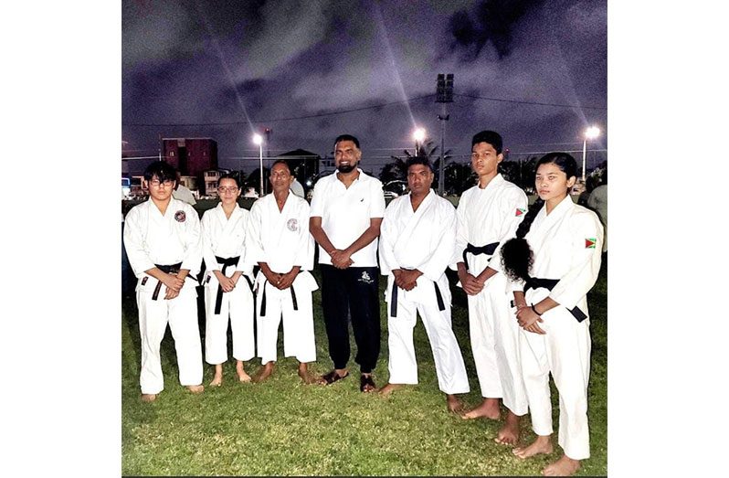 Jeffrey Wong and his students duirng a photo opportunity with Presdient Irfaan Ali