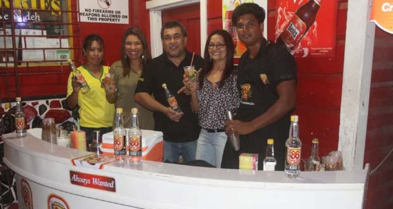 Jerry Bacchus (third from left) is flanked by his wife (to his left) and representatives of the Cachaca Vodka, which was launched at his location.