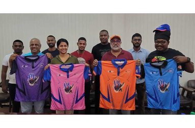 Commissioners and staff of the Ethnic Relations Commission display the jerseys that will be gifted to the four semi-finalists on Sunday. Representatives from the remaining teams are also present.